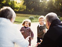 Zwei Enkelkinder laufen auf ihre Großeltern zu 